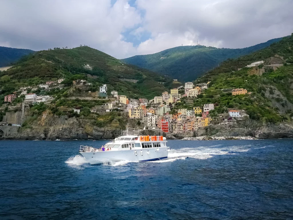 Photo of a yacht sailing near a coastal village